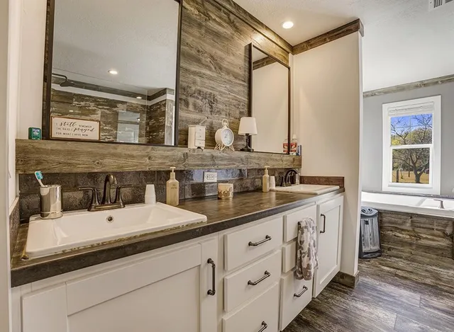 a bathroom with a double vanity sink and a window