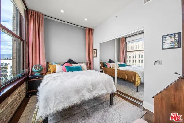 a bed sitting in a bedroom next to a window