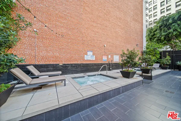 a view of a patio with chairs and potted plants