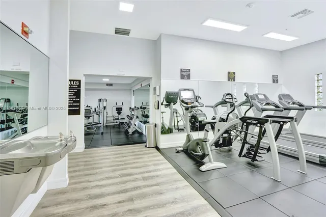 a living room with lots of chairs and appliances
