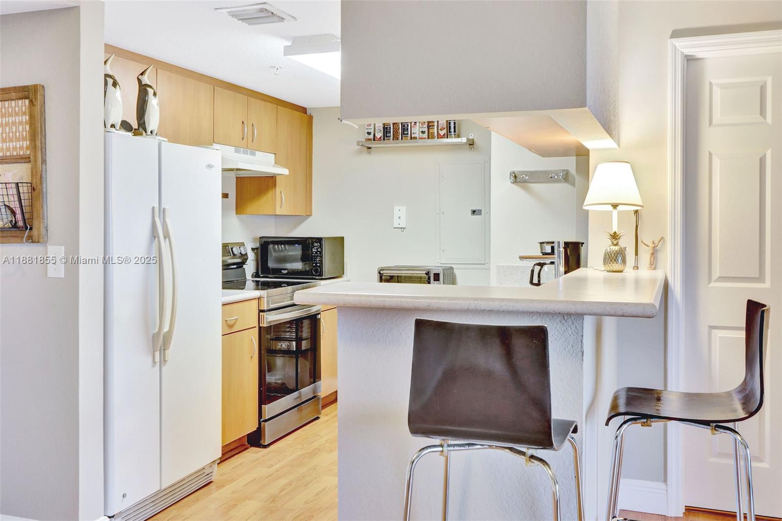 816 Northwest 11th Street, Unit 905 Miami, FL 33136 - Photo 3 of 14 a kitchen with stainless steel appliances a sink stove and refrigerator