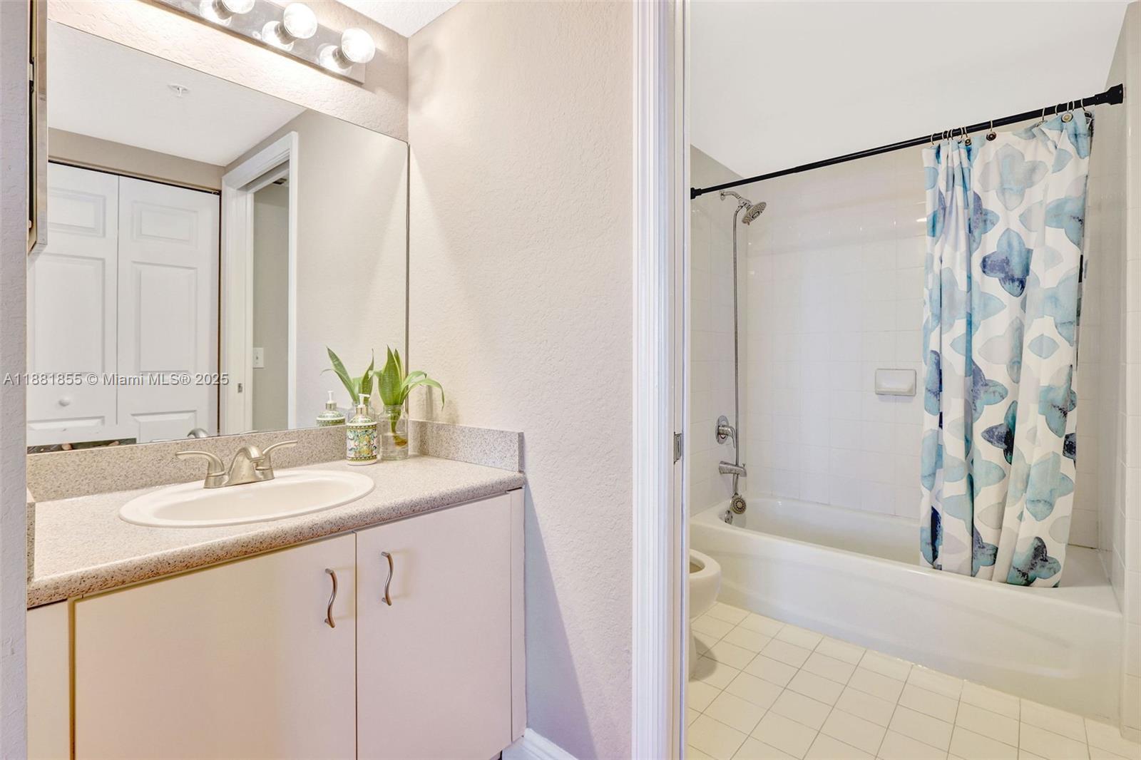 816 Northwest 11th Street, Unit 905 Miami, FL 33136 - Photo 7 of 14 a bathroom with a double vanity sink and a mirror