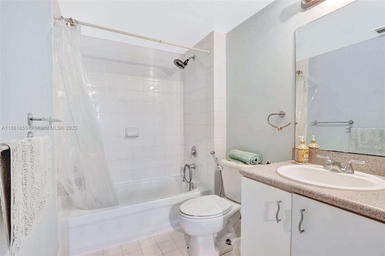 816 Northwest 11th Street, Unit 905 Miami, FL 33136 - Photo 9 of 14 a bathroom with a sink a toilet and shower