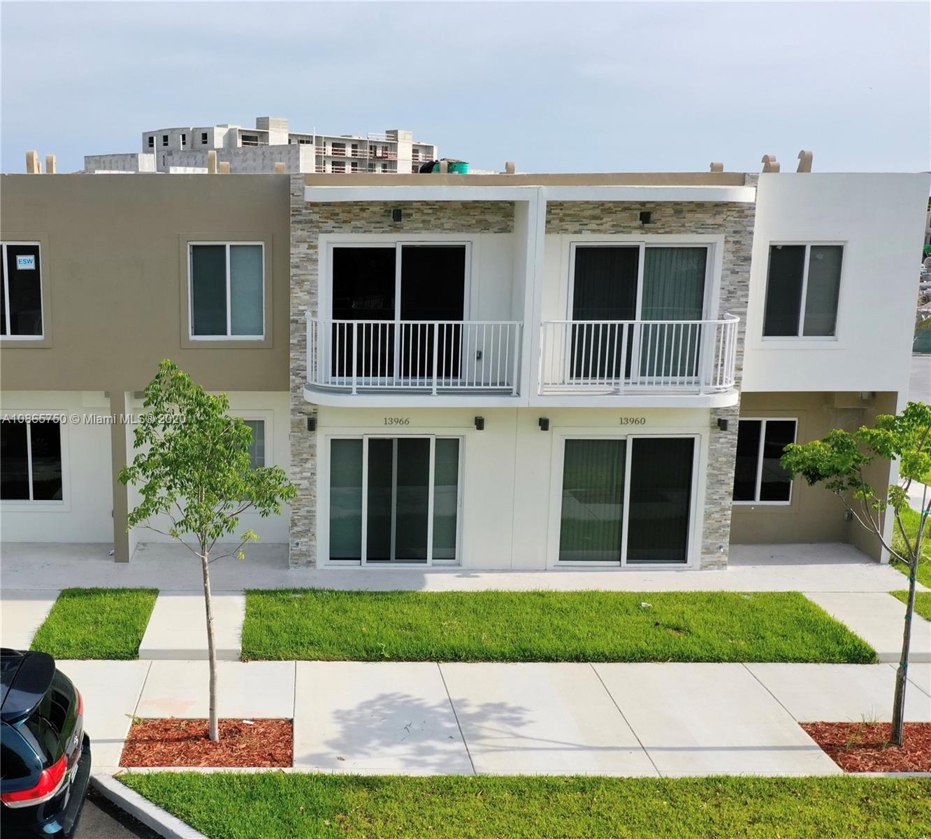 13966 Southwest 259th Terrace Homestead, FL 33032 - Photo 1 of 27 a view of white house with a yard and plants