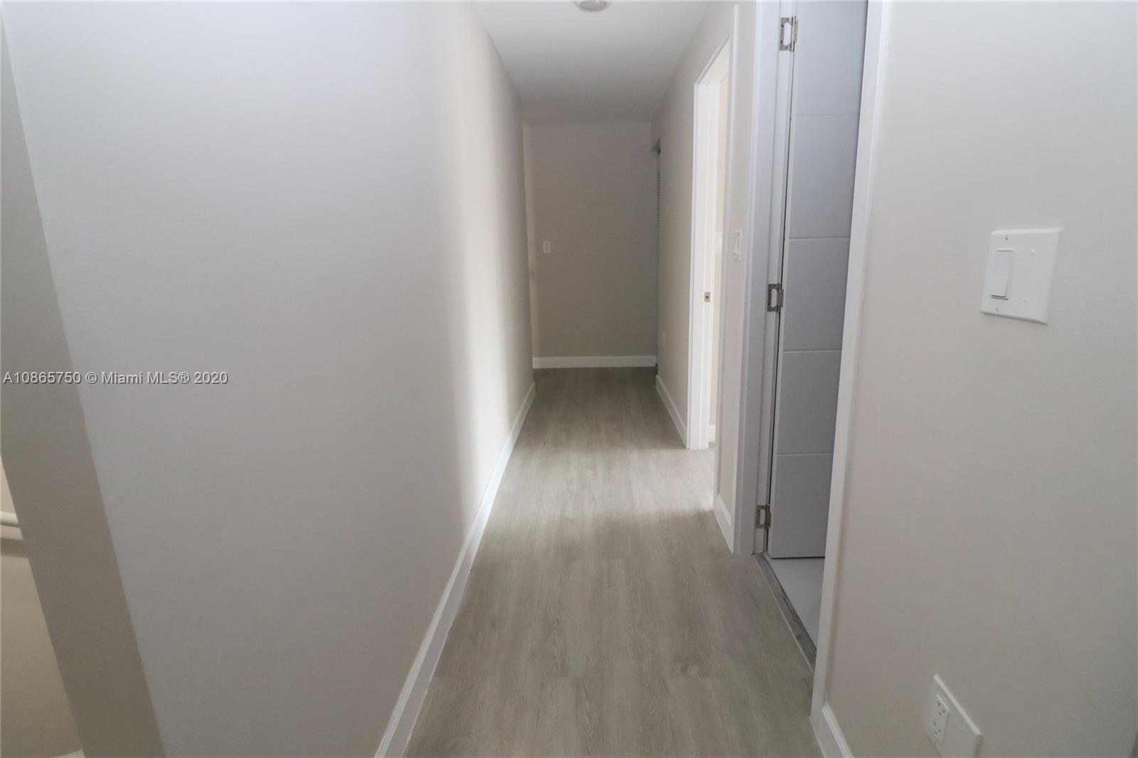 13966 Southwest 259th Terrace Homestead, FL 33032 - Photo 18 of 27 a view of a hallway with wooden floor