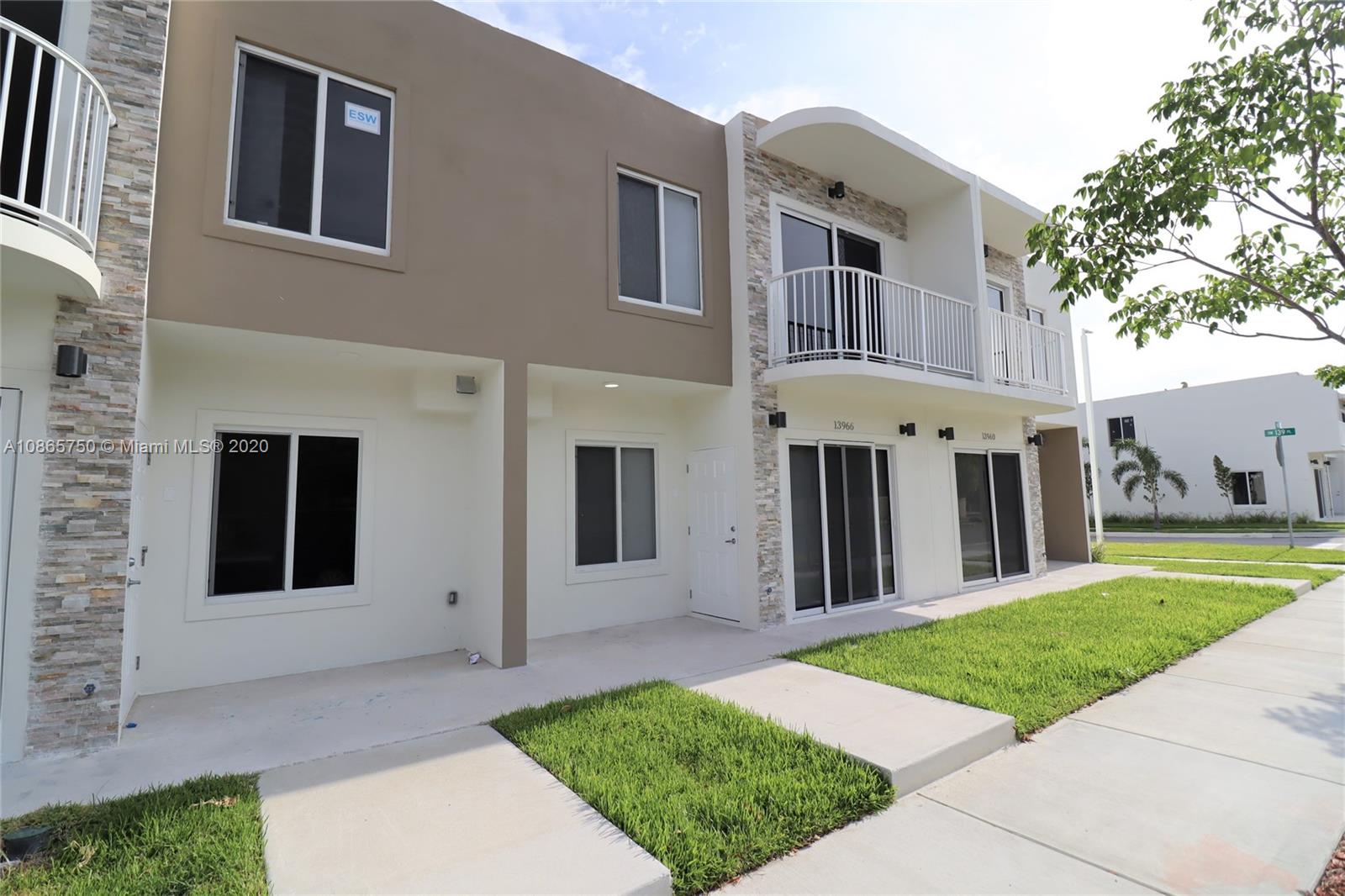 13966 Southwest 259th Terrace Homestead, FL 33032 - Photo 2 of 27 a front view of a house with a yard