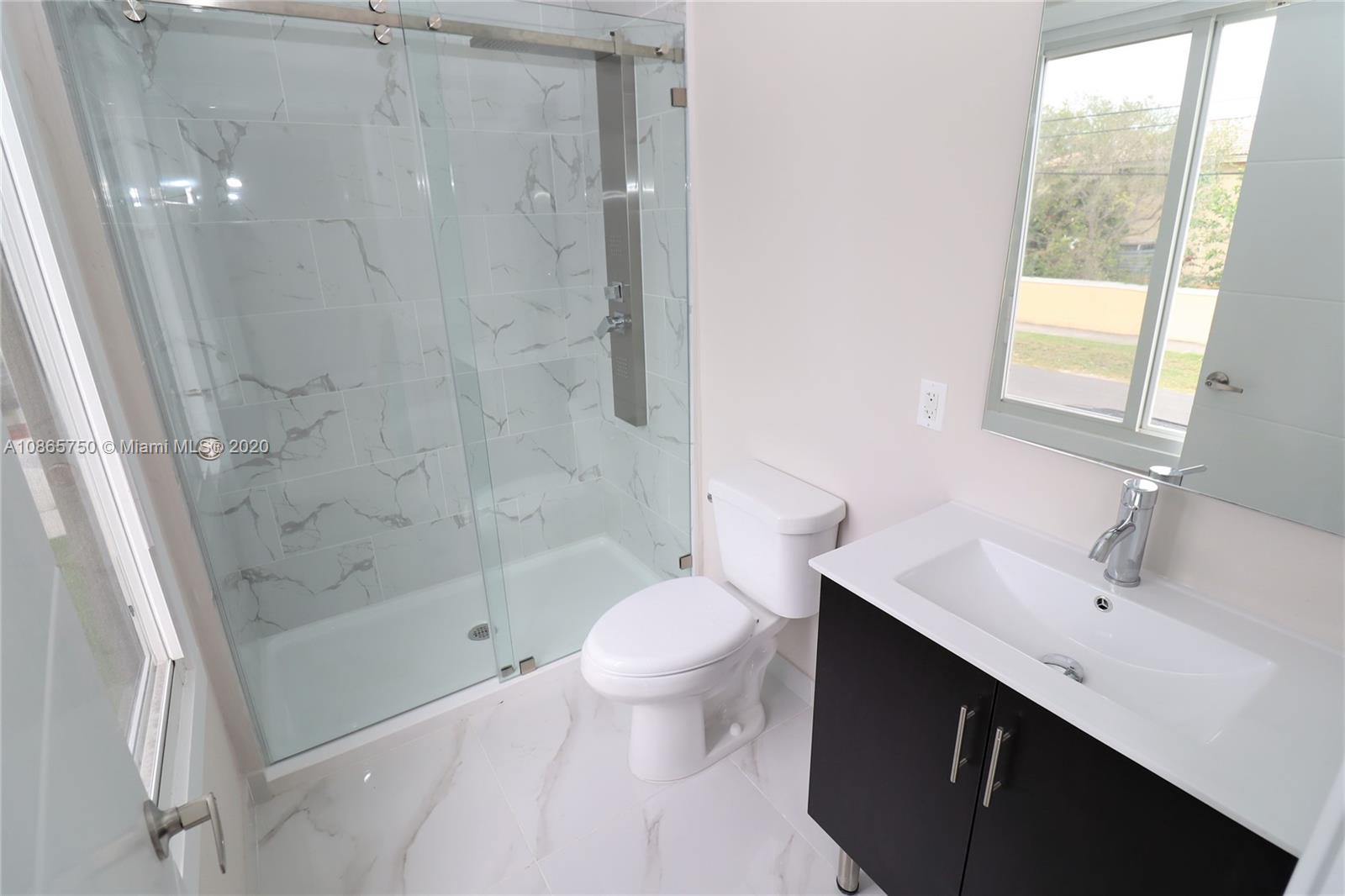 13966 Southwest 259th Terrace Homestead, FL 33032 - Photo 22 of 27 a bathroom with a bathtub shower sink mirror and toilet