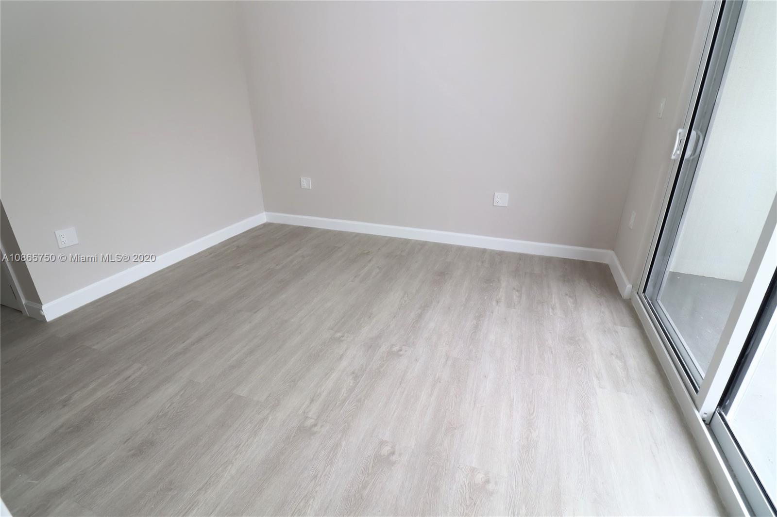 13966 Southwest 259th Terrace Homestead, FL 33032 - Photo 23 of 27 a view of an empty room with wooden floor and a window