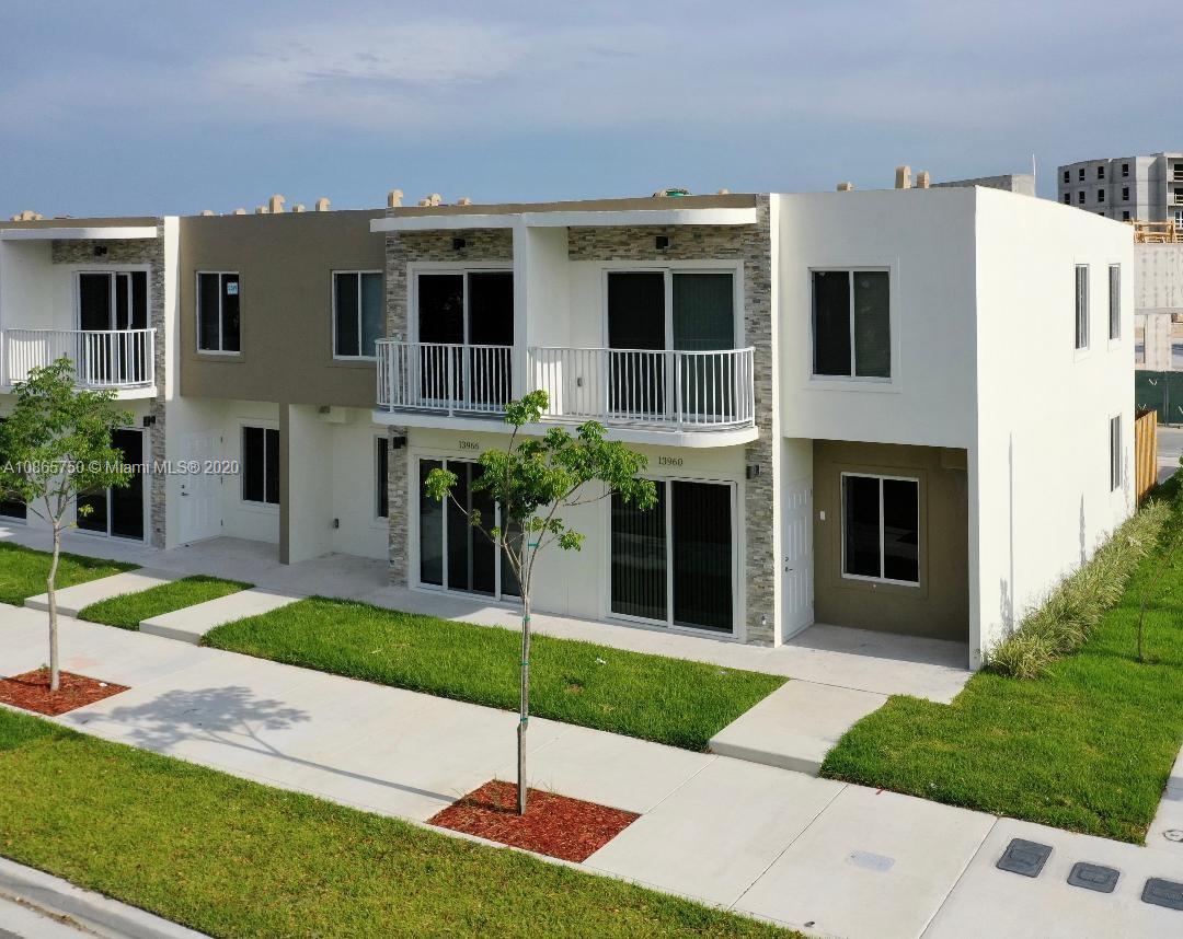 13966 Southwest 259th Terrace Homestead, FL 33032 - Photo 5 of 27 a front view of a house with a yard and trees