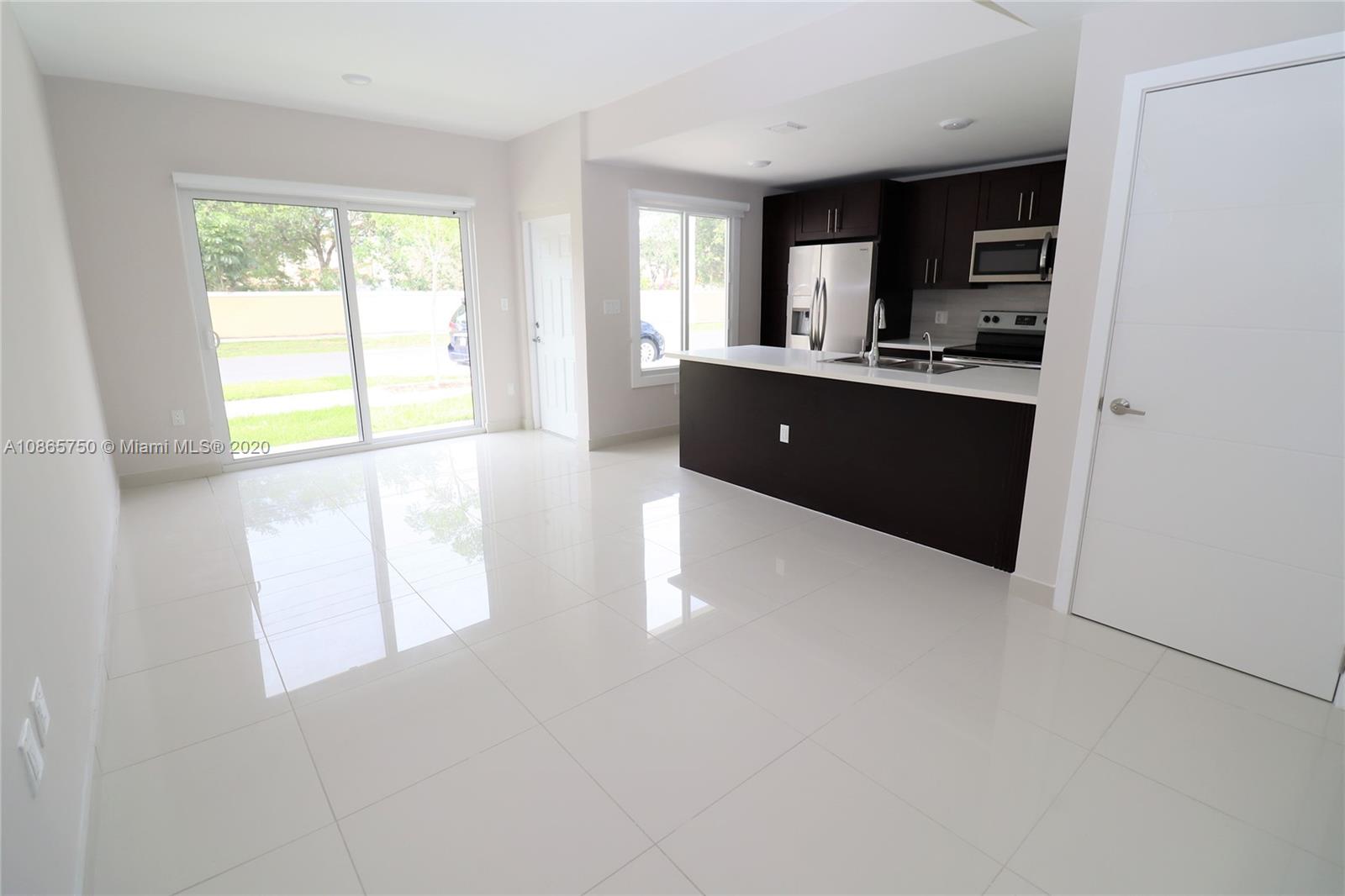 13966 Southwest 259th Terrace Homestead, FL 33032 - Photo 7 of 27 a kitchen with stainless steel appliances a refrigerator sink and cabinets