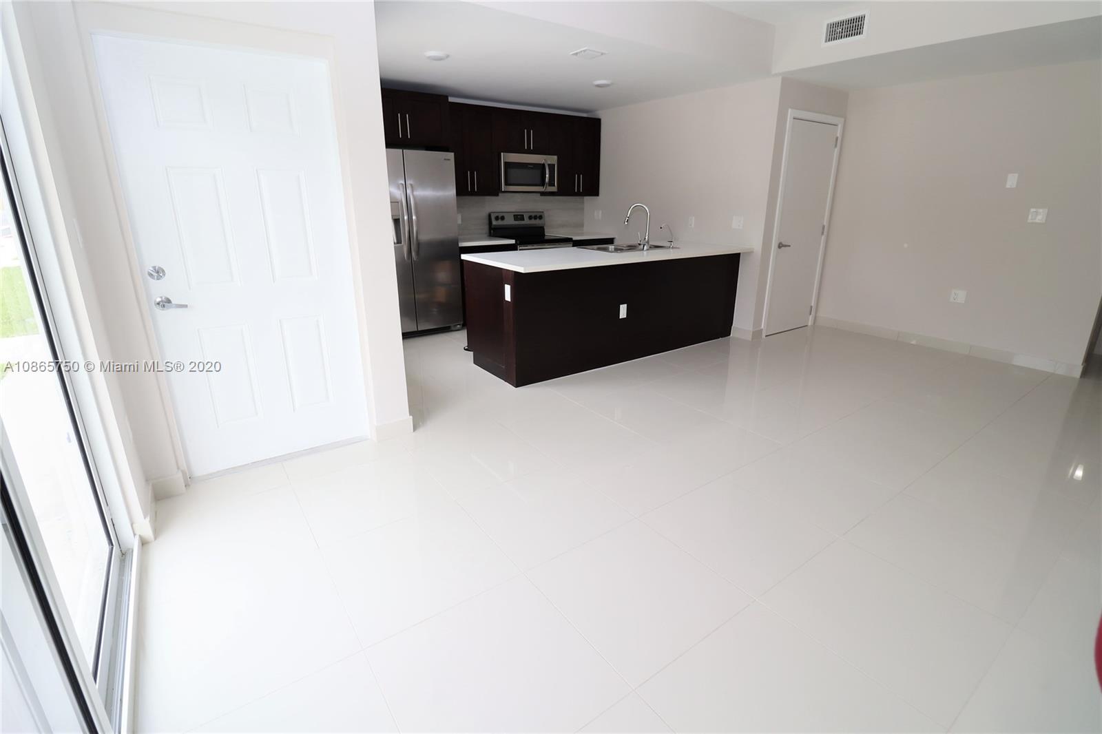 13966 Southwest 259th Terrace Homestead, FL 33032 - Photo 10 of 27 a room with furniture and a flat screen tv