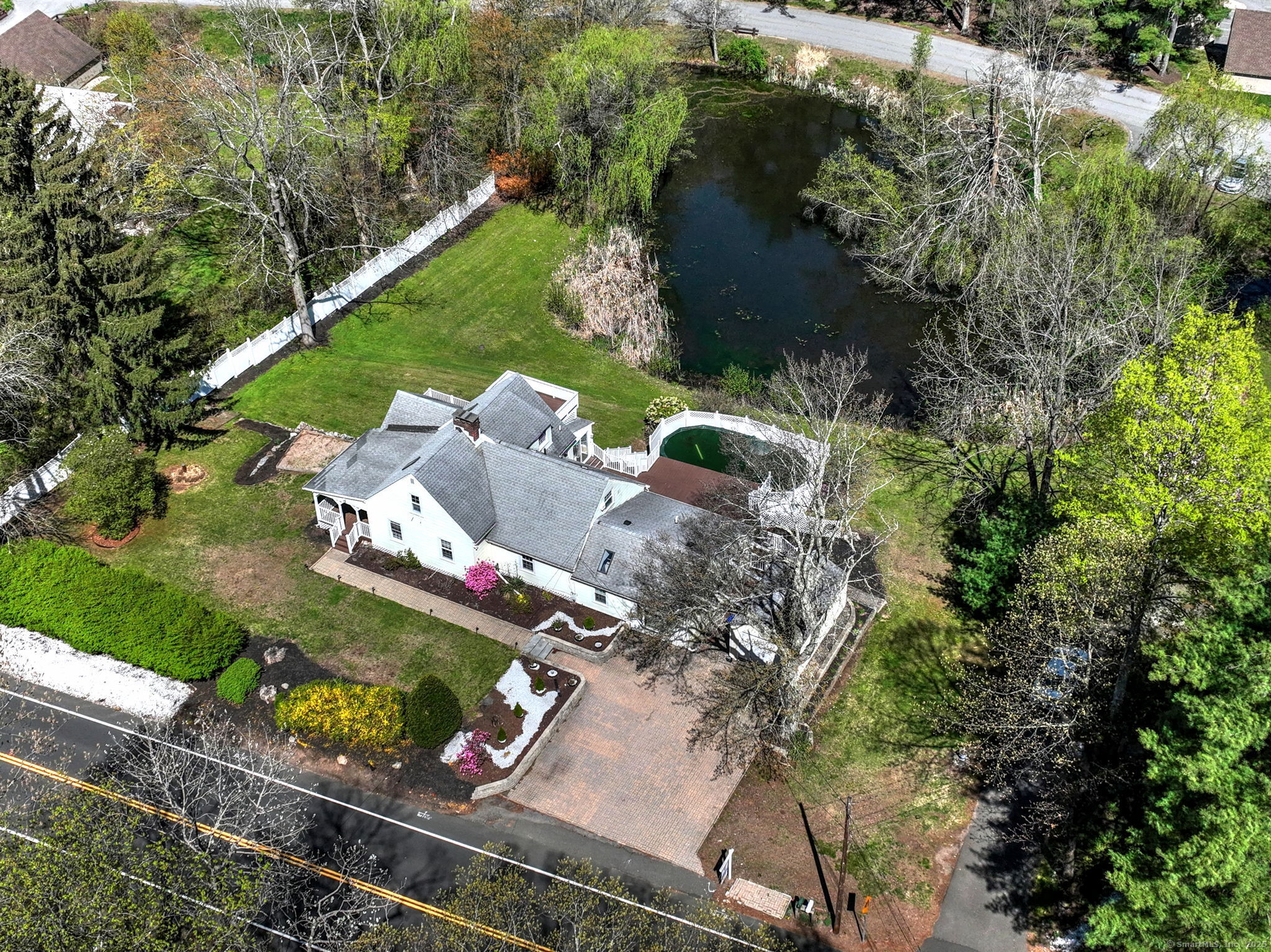 an aerial view of a house with a yard