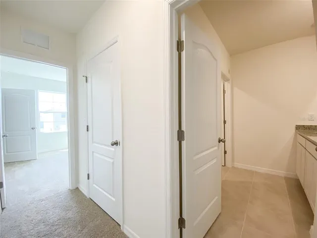 a bathroom with a granite countertop bathtub shower sink mirror and toilet