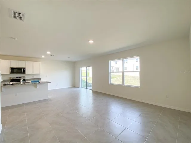 a view of a kitchen with a sink and a refrigerator in it