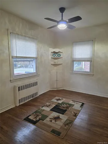 a living room with hard wood floor and a window