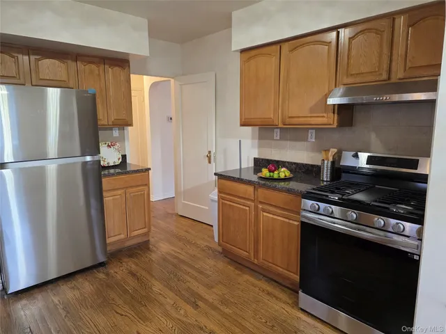 a kitchen with a refrigerator stove and microwave