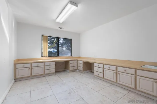 a large white kitchen with a sink