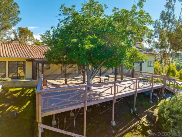 a view of house with backyard and sitting area