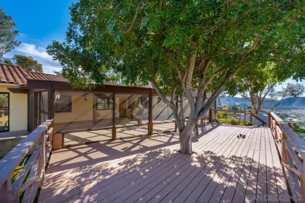 a view of backyard with a deck and wooden floor