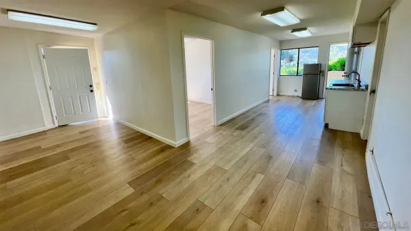 a view of an entryway with wooden floor