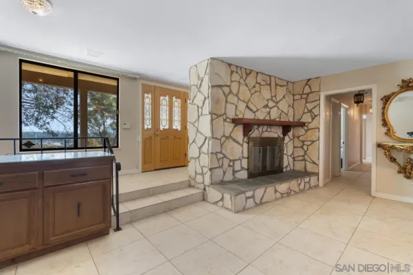 a living room with a fireplace furniture and a large window