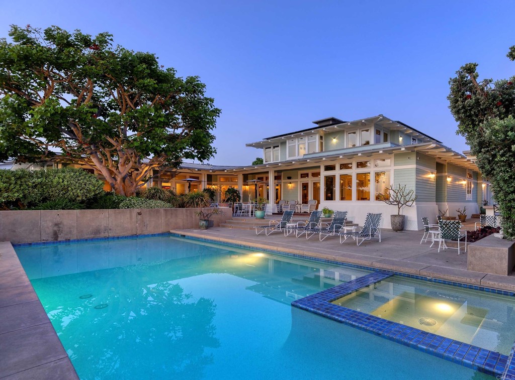 a view of a swimming pool with outdoor seating