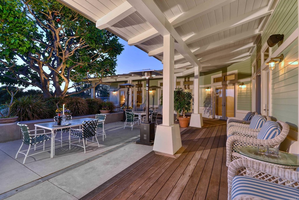 441 Oceanview Terrace Encinitas, CA 92024 - Photo 14 of 34 a view of a patio with dining table and chairs with wooden floor and fence