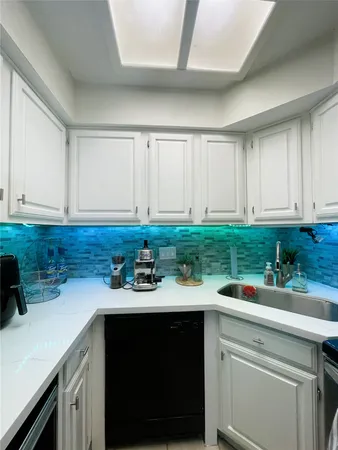 a kitchen with a sink and cabinets