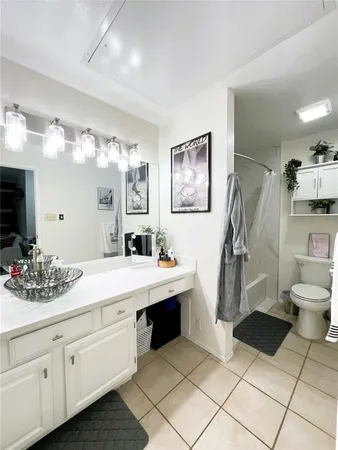 a spacious bathroom with a double vanity sink mirror and toilet