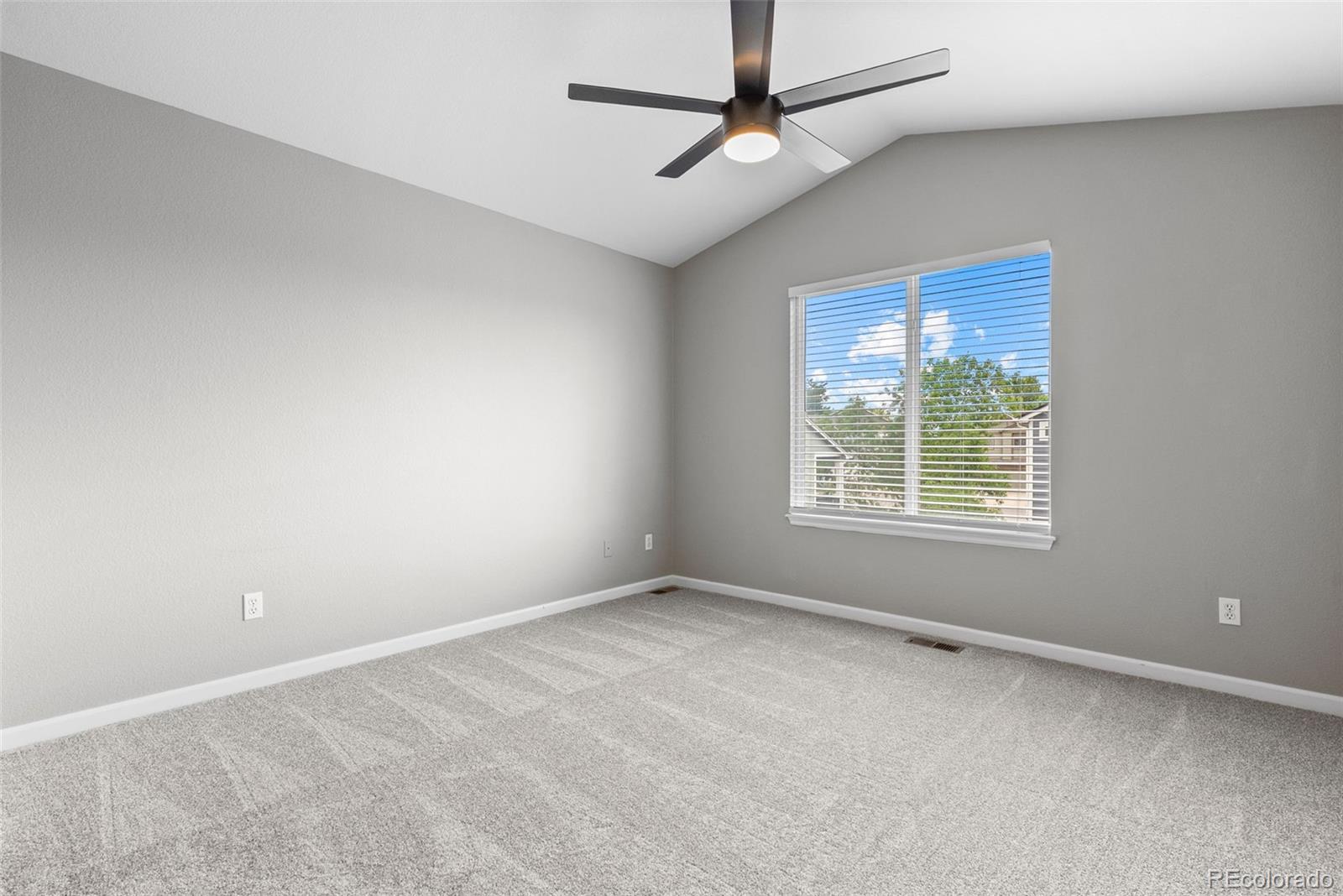 8743 Wildrye Circle Parker, CO 80134 - Photo 14 of 35 an empty room with a window and ceiling fan