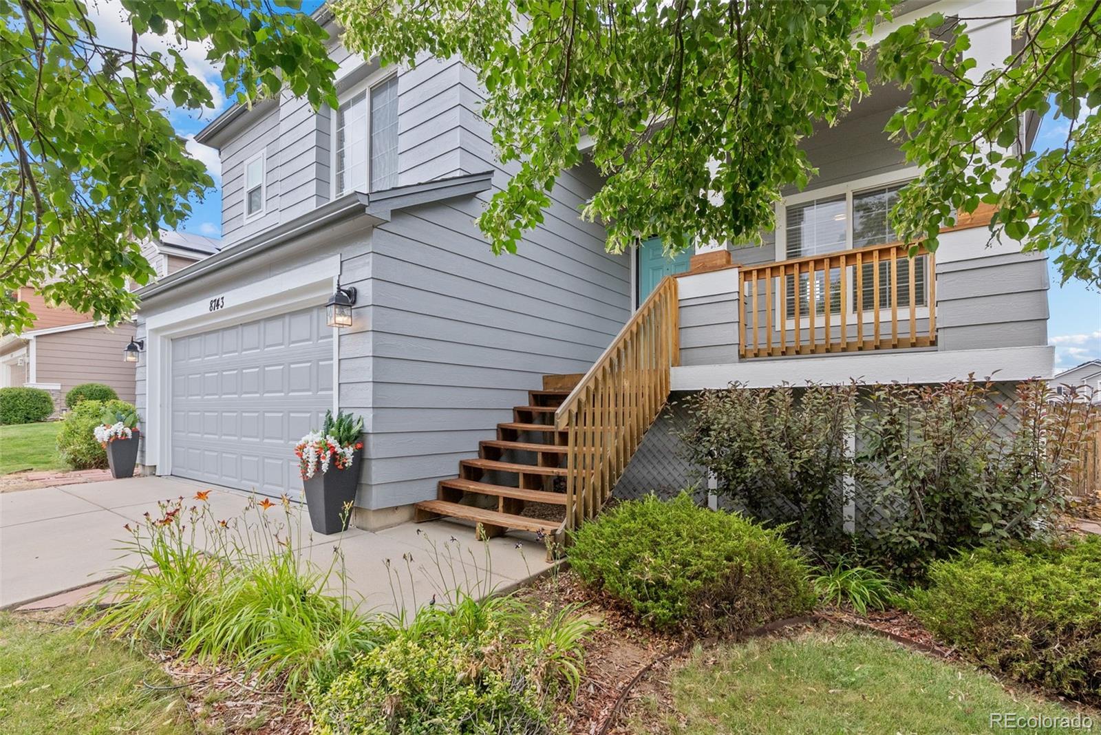 8743 Wildrye Circle Parker, CO 80134 - Photo 34 of 35 a view of a house with potted plants and a large tree