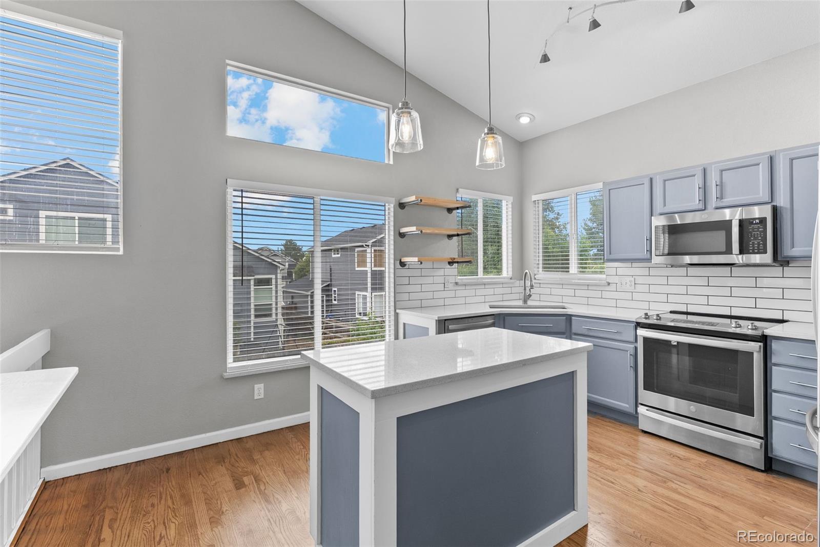 8743 Wildrye Circle Parker, CO 80134 - Photo 6 of 35 a kitchen with stainless steel appliances granite countertop a sink stove and refrigerator