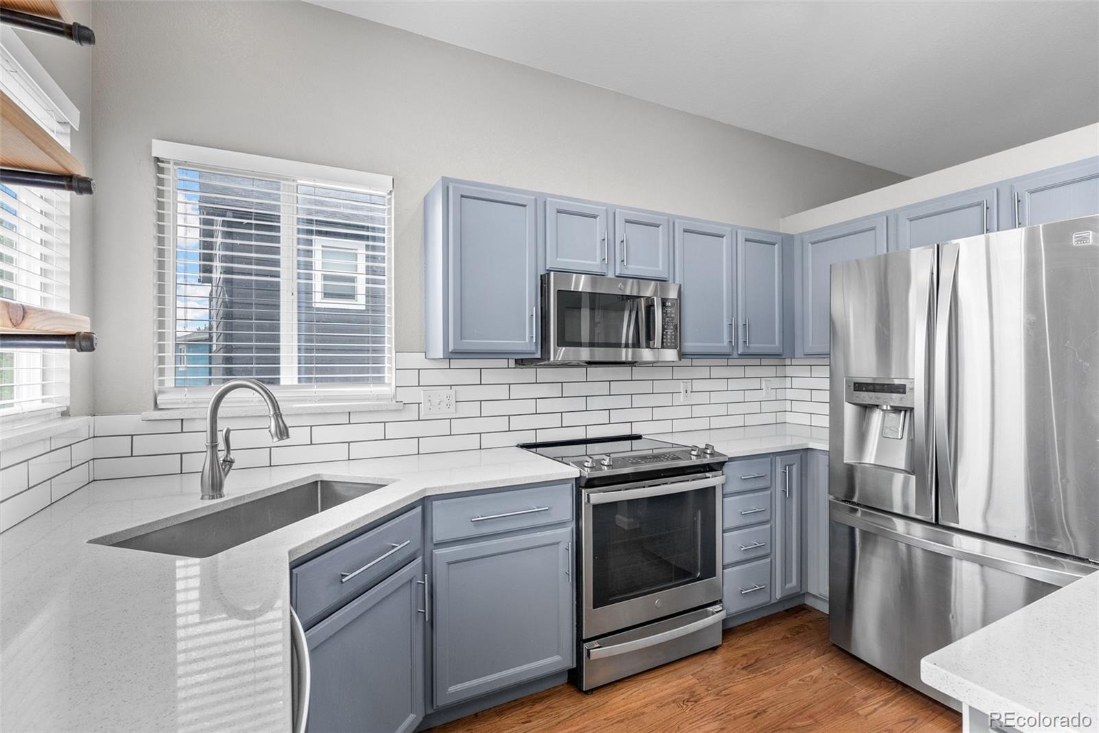8743 Wildrye Circle Parker, CO 80134 - Photo 8 of 35 a kitchen with a sink stove and refrigerator