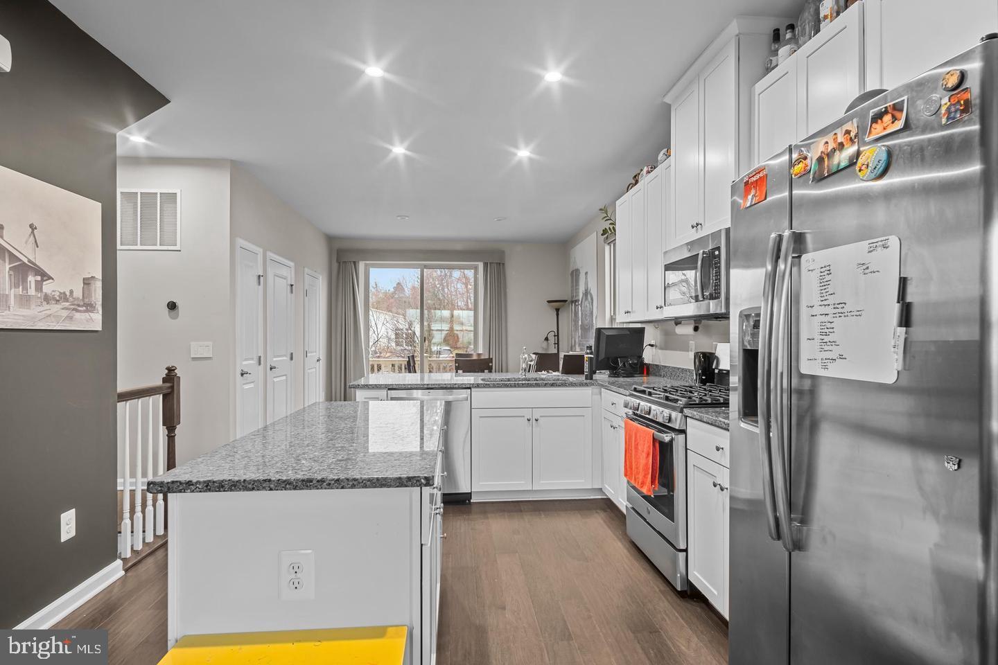 43821 Stubble Cor Square Ashburn, VA 20147 - Photo 12 of 25 a kitchen with stainless steel appliances granite countertop a sink refrigerator and cabinets