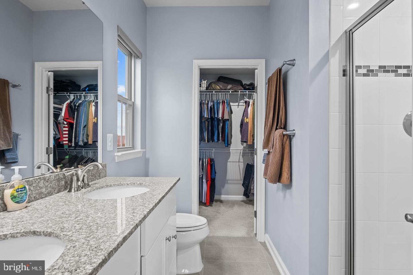 43821 Stubble Cor Square Ashburn, VA 20147 - Photo 16 of 25 a bathroom with a granite countertop sink a toilet and a shower