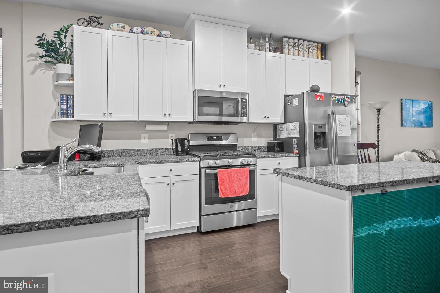 43821 Stubble Cor Square Ashburn, VA 20147 - Photo 4 of 25 a kitchen with stainless steel appliances granite countertop a sink stove and refrigerator