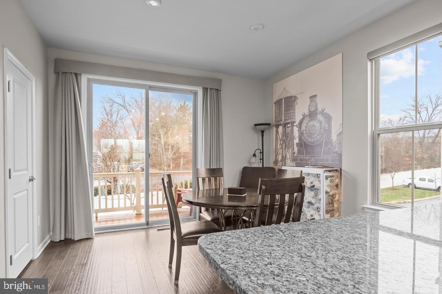 43821 Stubble Cor Square Ashburn, VA 20147 - Photo 7 of 25 a view of a dining room with furniture and wooden floor