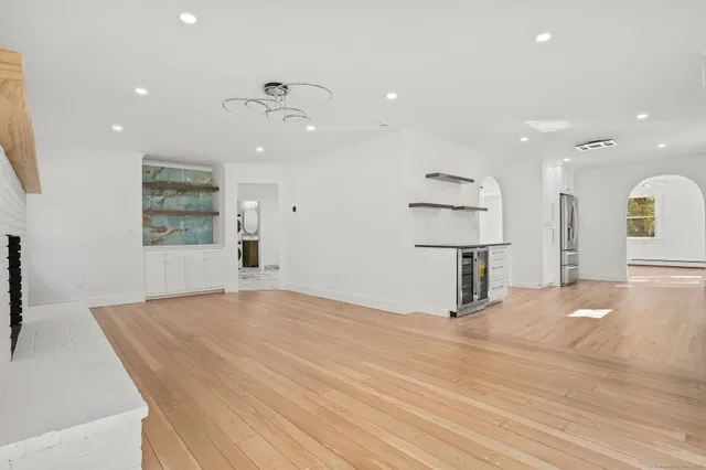 a kitchen with stainless steel appliances granite countertop a sink and cabinets with wooden floor