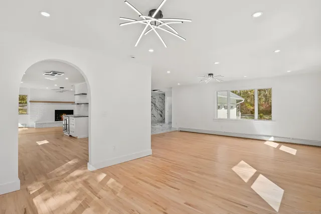 a kitchen with granite countertop white cabinets stainless steel appliances and a sink
