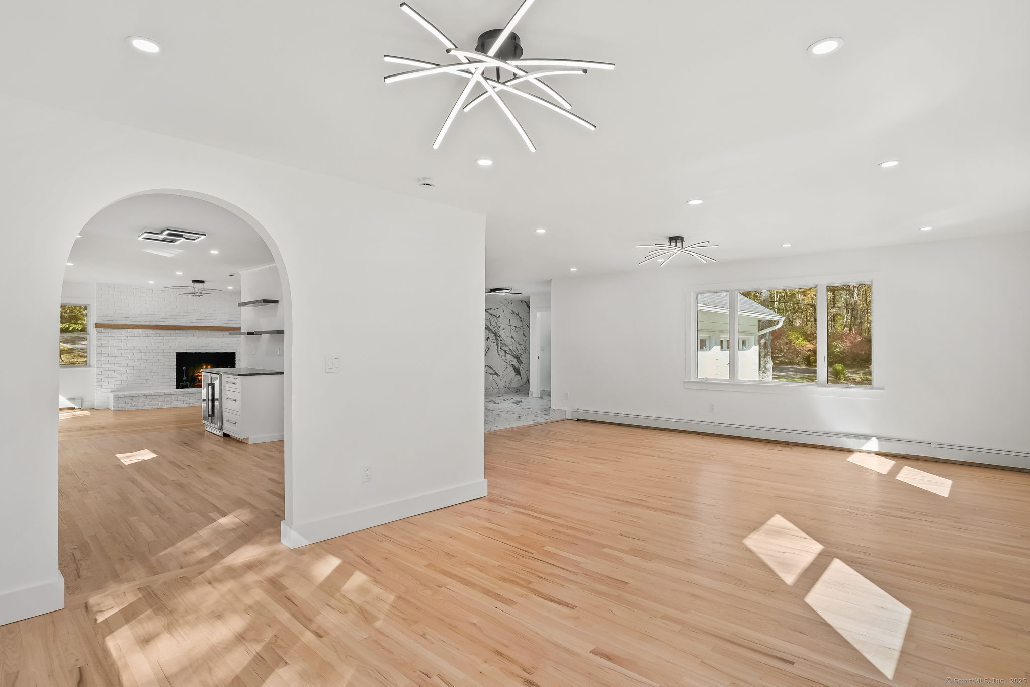4 Trails End Road Weston, CT 06883 - Photo 13 of 40 a view of empty room with wooden floor and fan