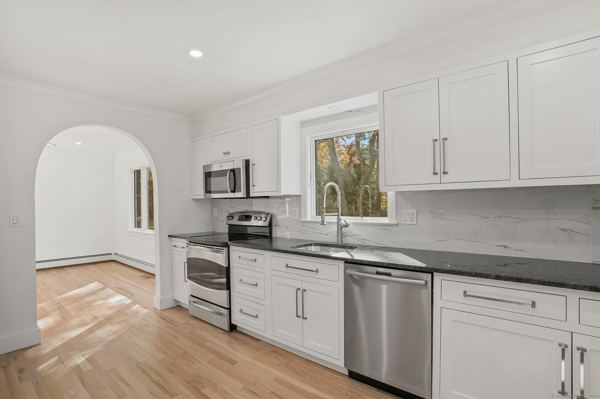 4 Trails End Road Weston, CT 06883 - Photo 15 of 40 a kitchen with stainless steel appliances granite countertop a sink and cabinets with wooden floor