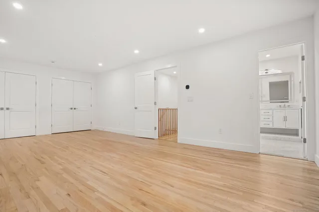 a bathroom with a granite countertop sink a toilet and shower
