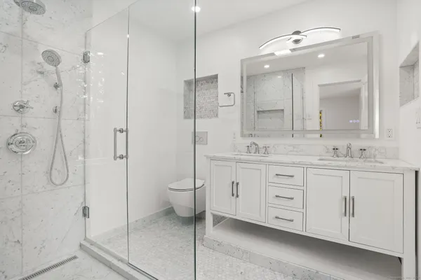 a view of swimming pool with wooden floor and fence next to a yard