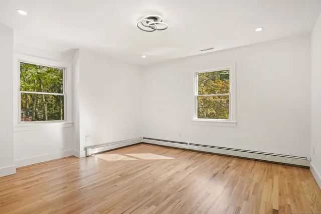 a view of a livingroom with stairs and a ceiling fan
