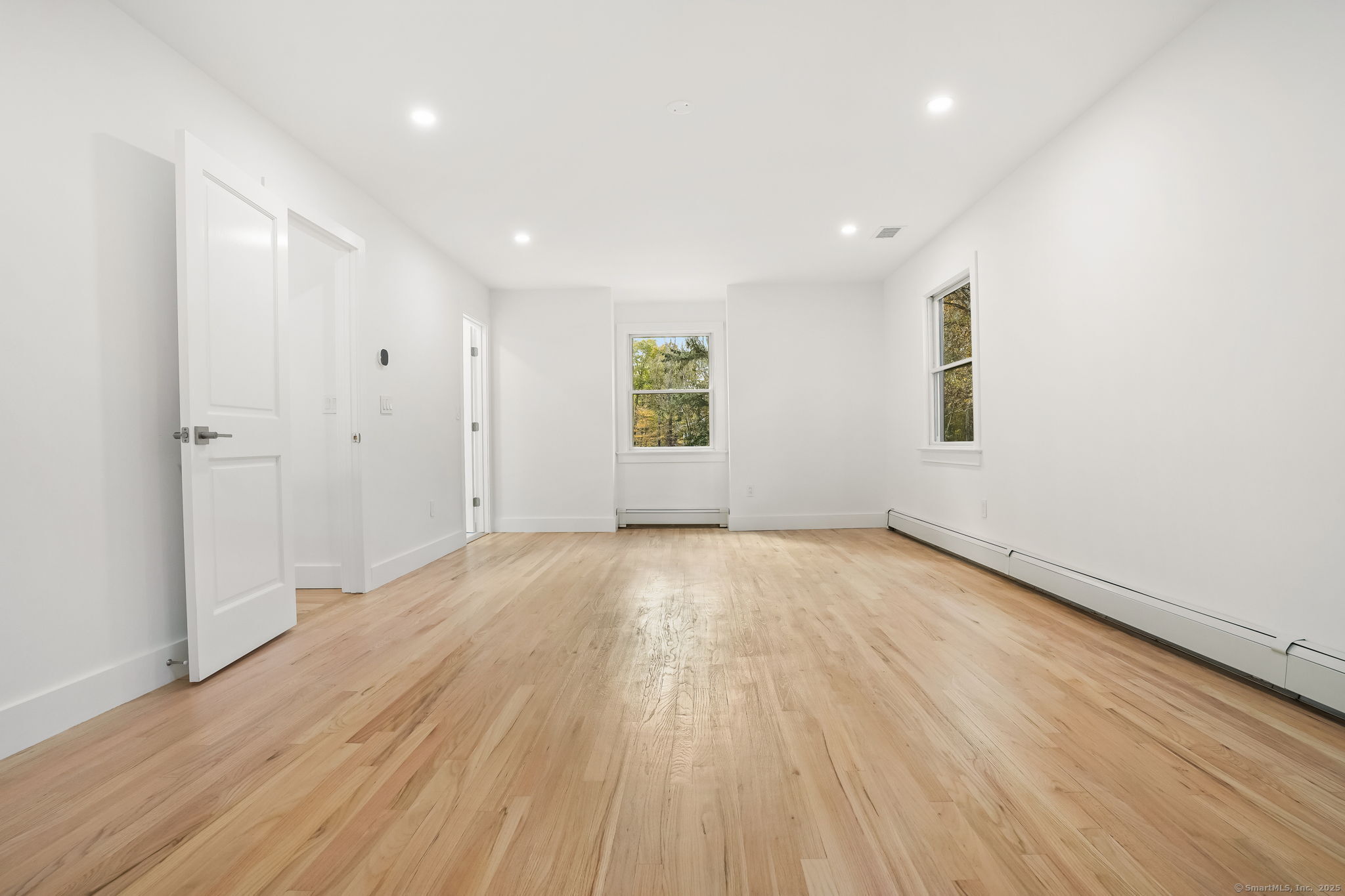 4 Trails End Road Weston, CT 06883 - Photo 27 of 40 an empty room with wooden floor and windows
