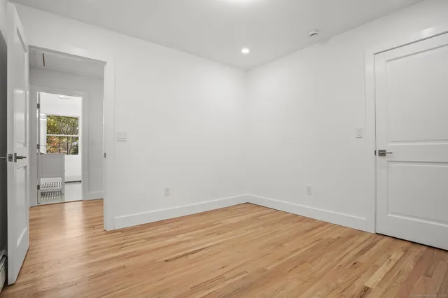a view of swimming pool with wooden floor and fence next to a yard