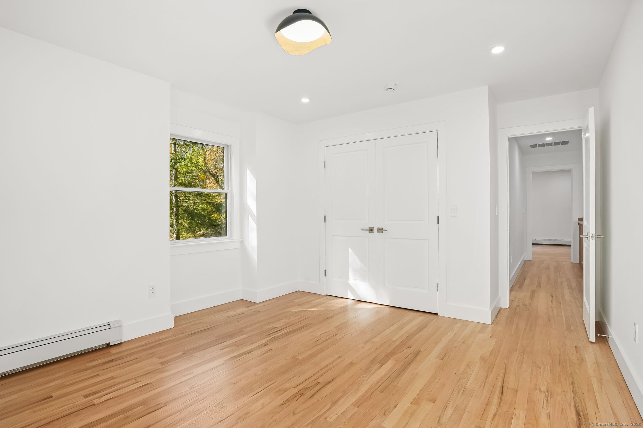 4 Trails End Road Weston, CT 06883 - Photo 32 of 40 a view of empty room with wooden floor and fan