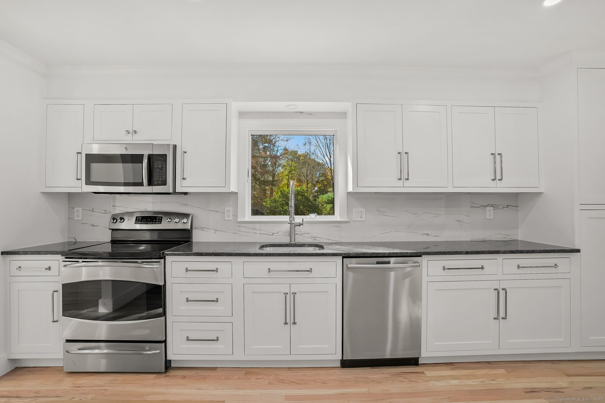 4 Trails End Road Weston, CT 06883 - Photo 34 of 40 a kitchen with granite countertop white cabinets stainless steel appliances and a sink