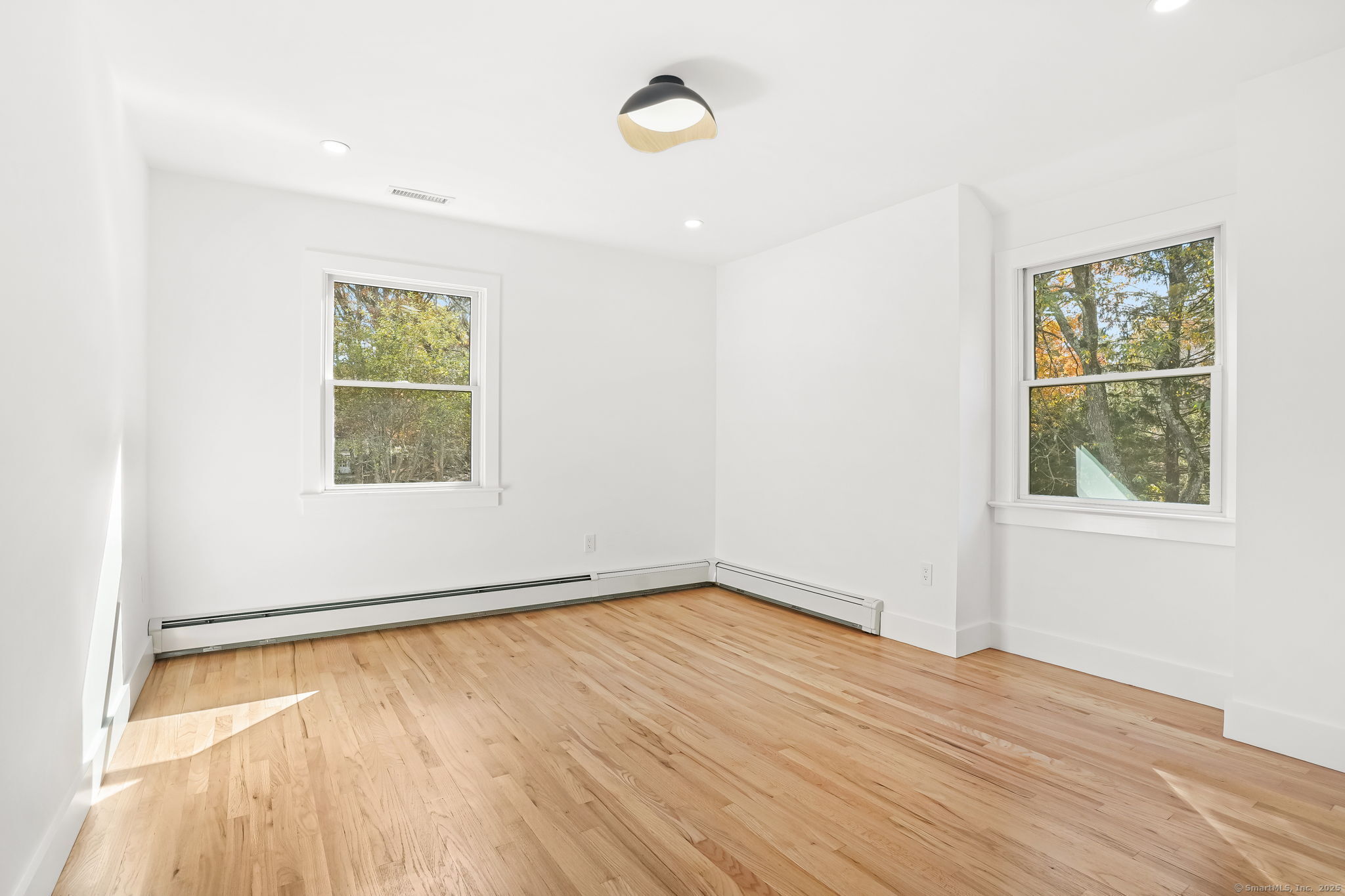 4 Trails End Road Weston, CT 06883 - Photo 8 of 40 an empty room with wooden floor and windows