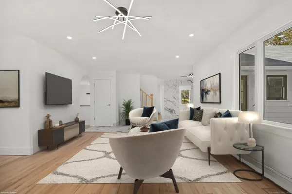 a large kitchen with stainless steel appliances a large counter top a stove a sink and a refrigerator